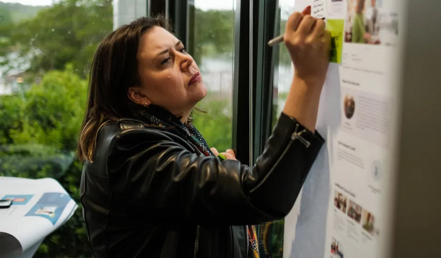 Professional women marking up a webpage mock up