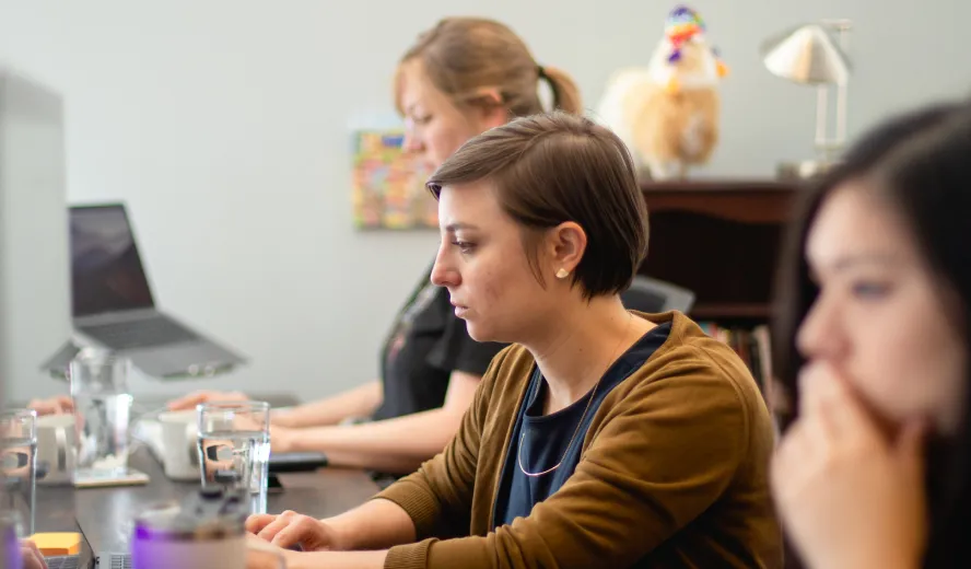 Developer working at a desk in a crowded office